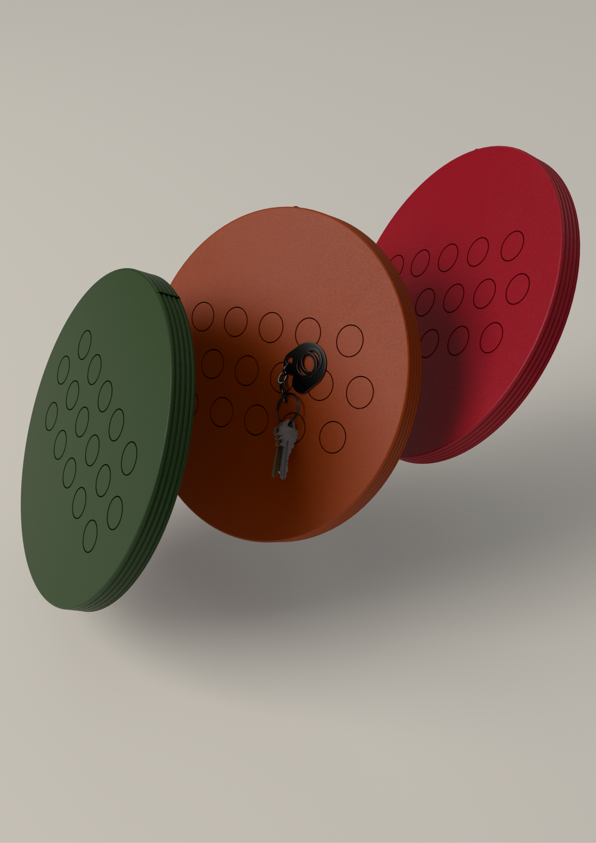 Set of three 3D-printed magnetic key holders in green, red, and orange PLA with textured surface, wall-mounted minimalist home organizer, modern entryway storage solution.